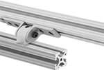 Image of ProductInUse. Inline with L Arms. Front orientation. T-Slotted Framing and Fittings. T-Slotted Framing Brackets, Heavy Duty Pivoting Brackets with Sleeve Bearings for Single Rails, Inline, L Arms.