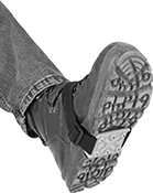 Image of Product. Grippers Shown In Use. Front orientation. Ice Cleats. Ice Cleats, Mid Shoe Coverage—Adjustable Strap with Buckle.