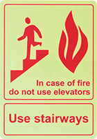 Image of Product. Front orientation. Signs. Glow-in-the-Dark Exit Signs, In Case of Fire Do Not Use Elevators—Use Stairways (English)—Glow-in-the-Dark Green with Red Message.