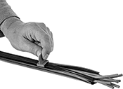 Image of ProductInUse. Slider. Front orientation. Wire Sleeving Installation Tools. Chemical-Resistant Interlocking Wraparound Wire Sleeving.